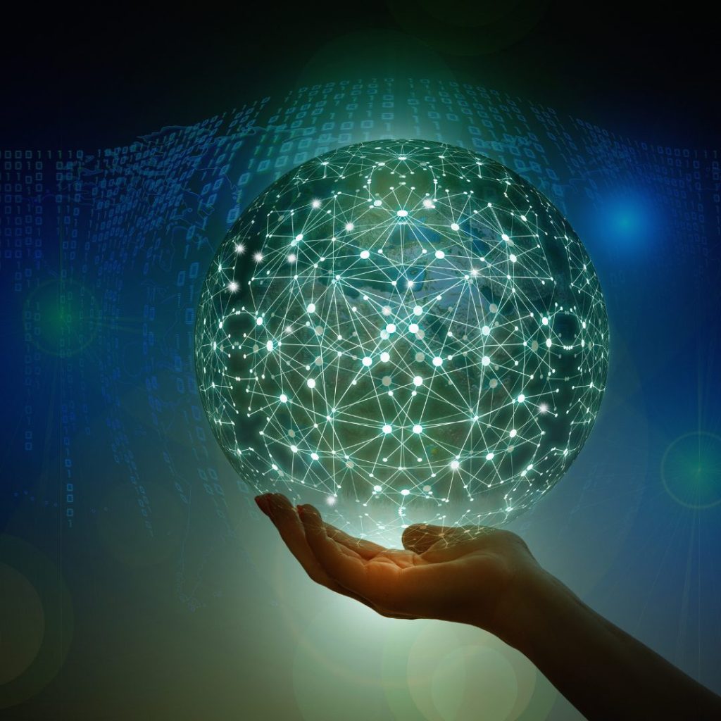 Digital network globe held by a human hand, symbolizing Artificial Intelligence and global connectivity. The glowing network represents innovation and technological advancement.